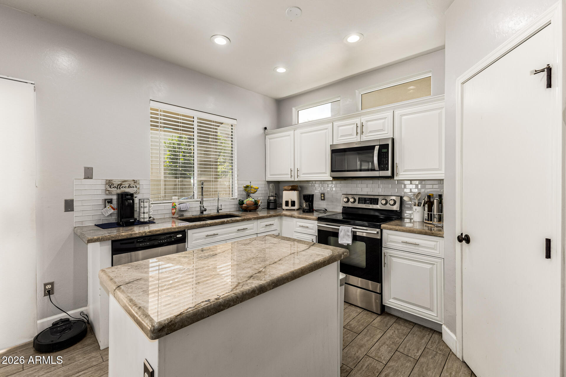 4237 East Orchid Lane Gilbert, AZ 85296 - Photo 15 of 33 a kitchen with a sink stove and microwave