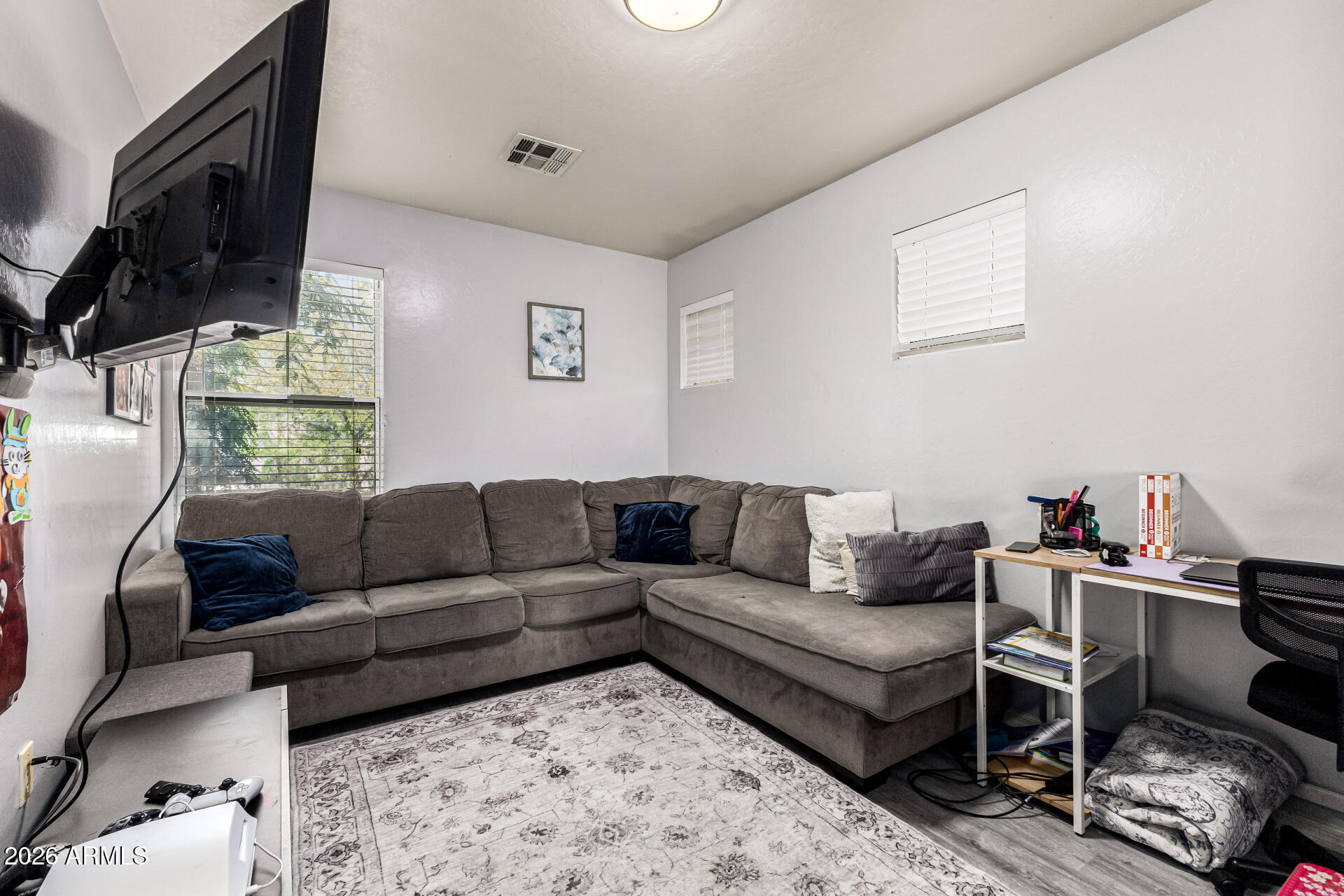 4237 East Orchid Lane Gilbert, AZ 85296 - Photo 16 of 33 a living room with furniture a flat screen tv and a window