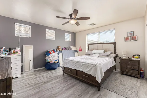 a bedroom with a bed and wooden floor
