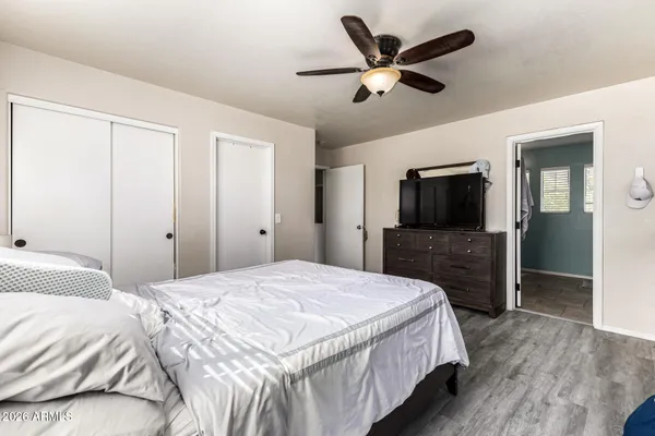 a bedroom with a bed and a flat screen tv