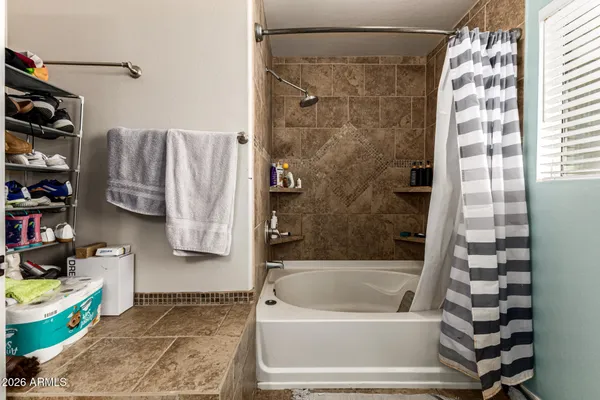 a bathroom with a bathtub and a shower