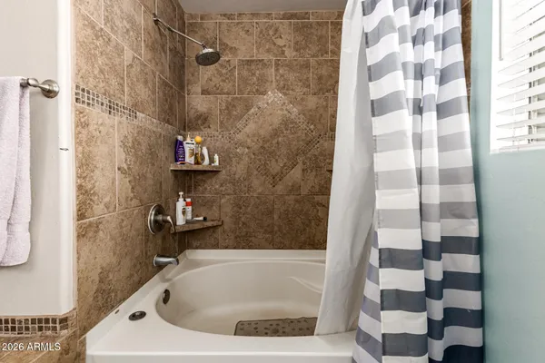 a bathroom with a bathtub and a shower