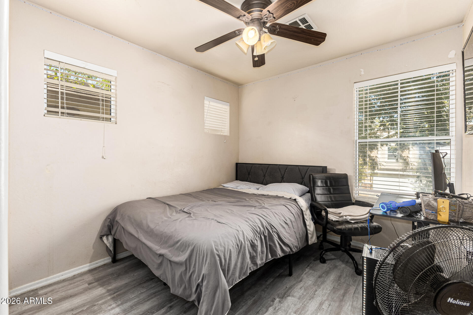 4237 East Orchid Lane Gilbert, AZ 85296 - Photo 24 of 33 a bedroom with a bed and wooden floor