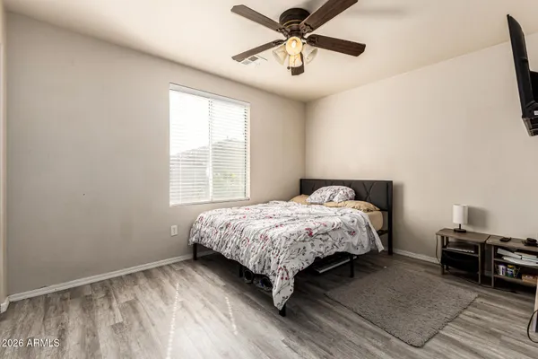 a bedroom with a bed and a ceiling fan