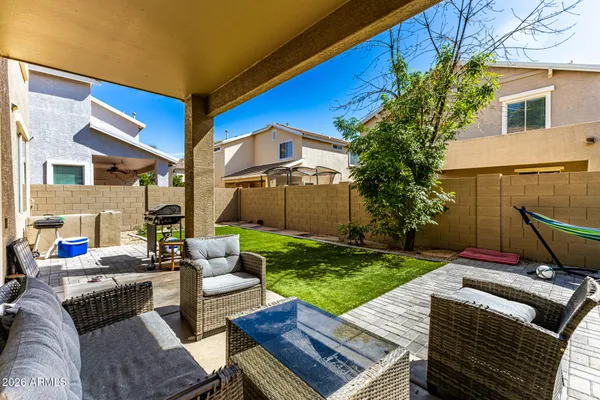 a view of a patio with couches and a table and chairs with garden view
