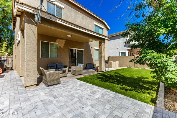 a view of a patio with couches table and chairs and potted plants