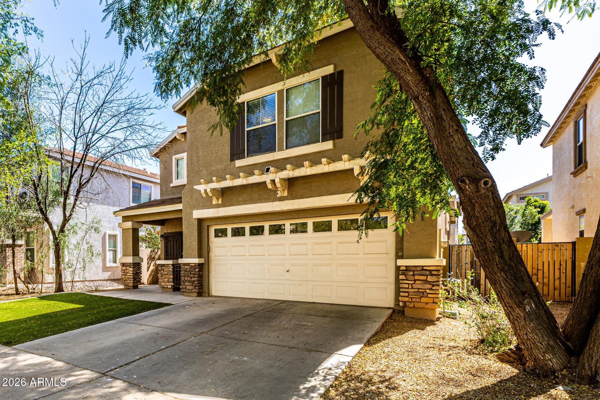 4237 East Orchid Lane Gilbert, AZ 85296 - Photo 6 of 33 a front view of a house with a yard