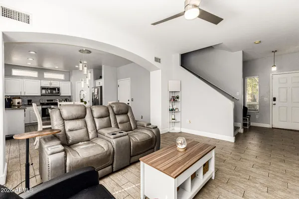 a living room with furniture and kitchen view