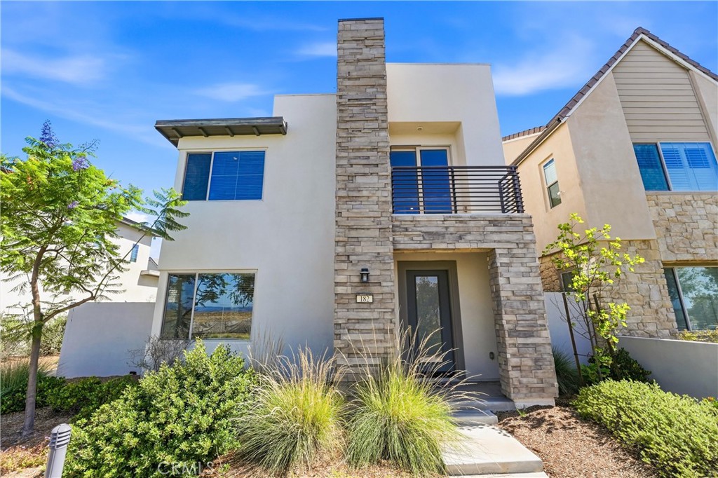 182 Scale Irvine, CA 92618 - Photo 3 of 61 This is the one. Stone facade, Juliet balcony, blue sky. Welcome to 182 Scale.