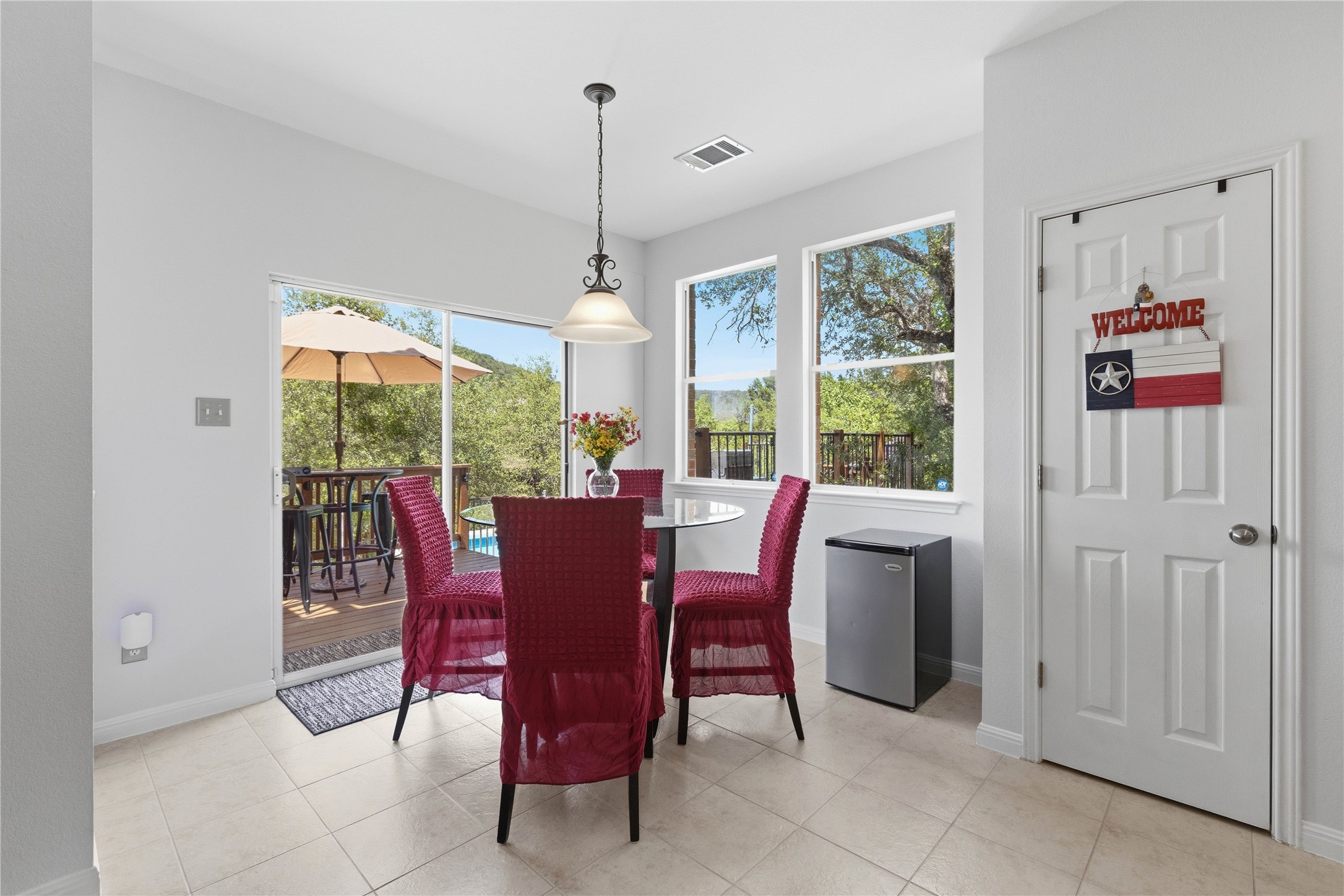 8122 Lime Creek Road Volente, TX 78641 - Photo 14 of 40 Family dining overlooking hill country views and the pool