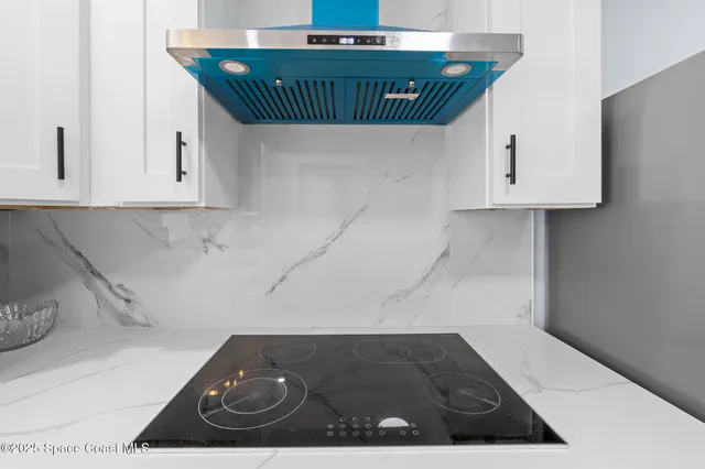 a kitchen with a sink a stove and a microwave