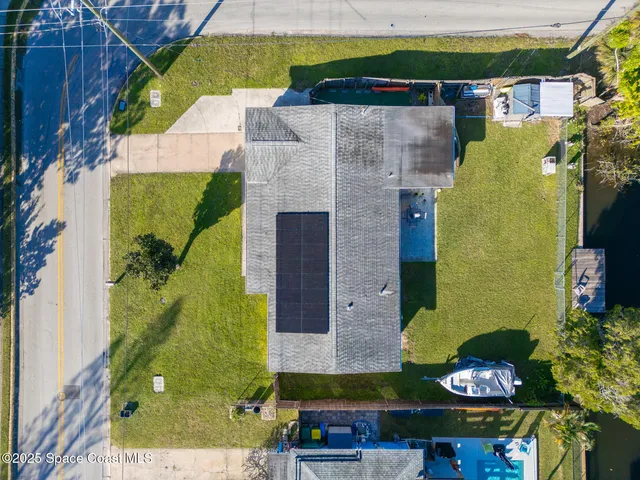 an aerial view of a house with a swimming pool