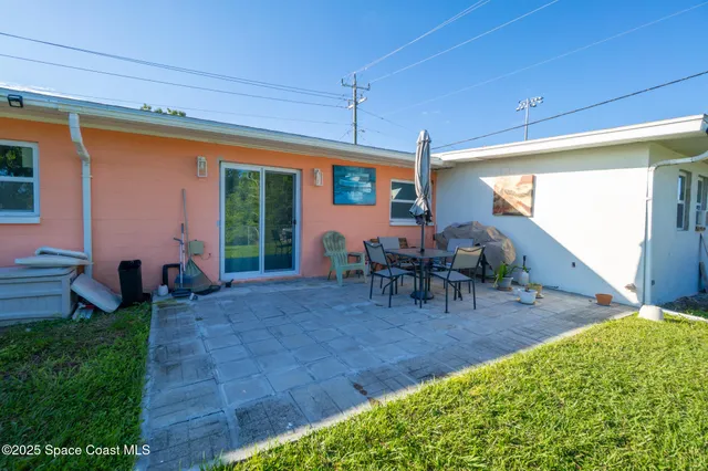 a view of a porch with chairs and backyard