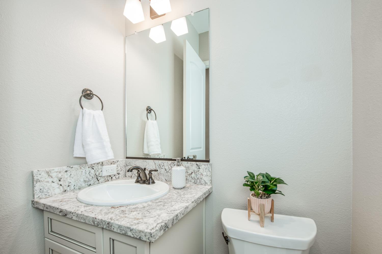 598 Crescent Lane Madera, CA 93636 - Photo 12 of 80 a bathroom with a granite countertop sink and a mirror