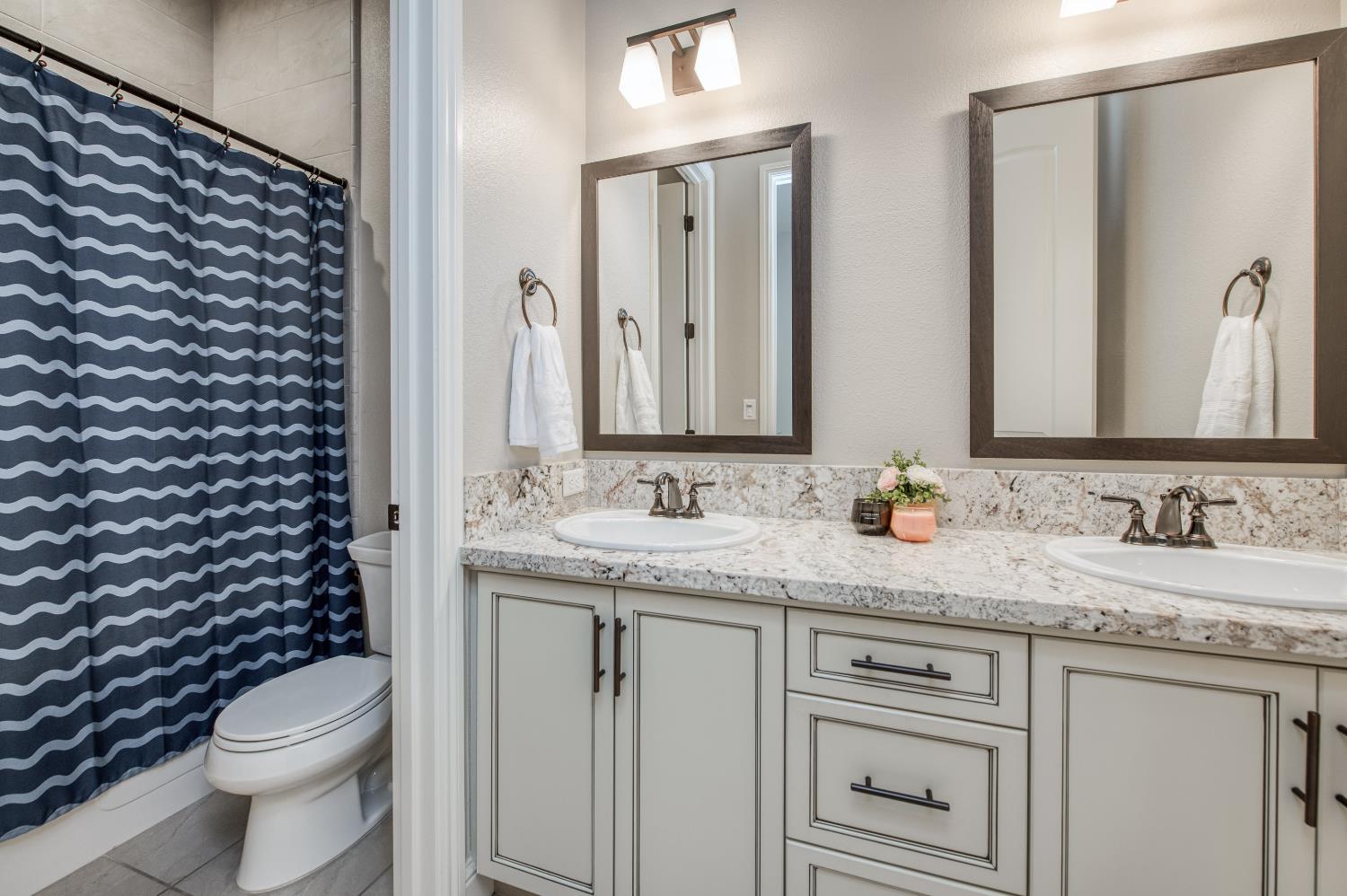 598 Crescent Lane Madera, CA 93636 - Photo 14 of 80 a bathroom with a granite countertop sink toilet and mirror