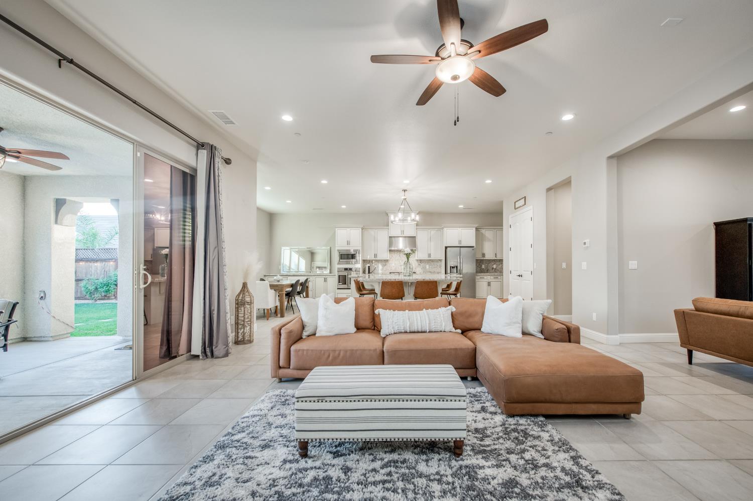 598 Crescent Lane Madera, CA 93636 - Photo 15 of 80 a living room with furniture and a chandelier