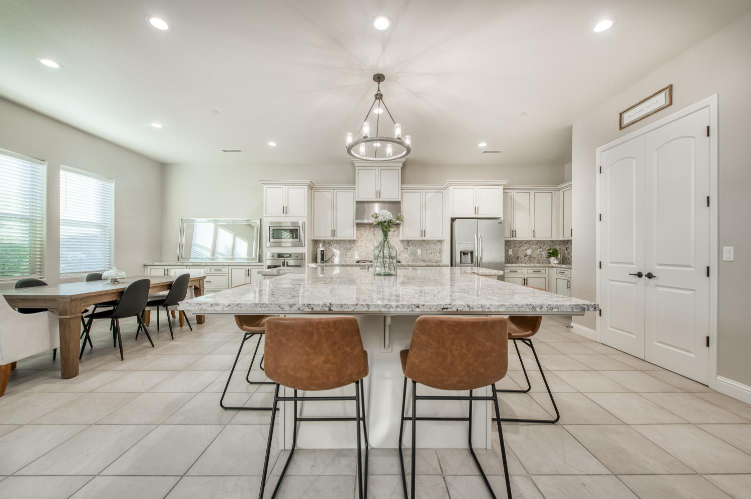 598 Crescent Lane Madera, CA 93636 - Photo 20 of 80 a kitchen with stainless steel appliances granite countertop a table and chairs in it