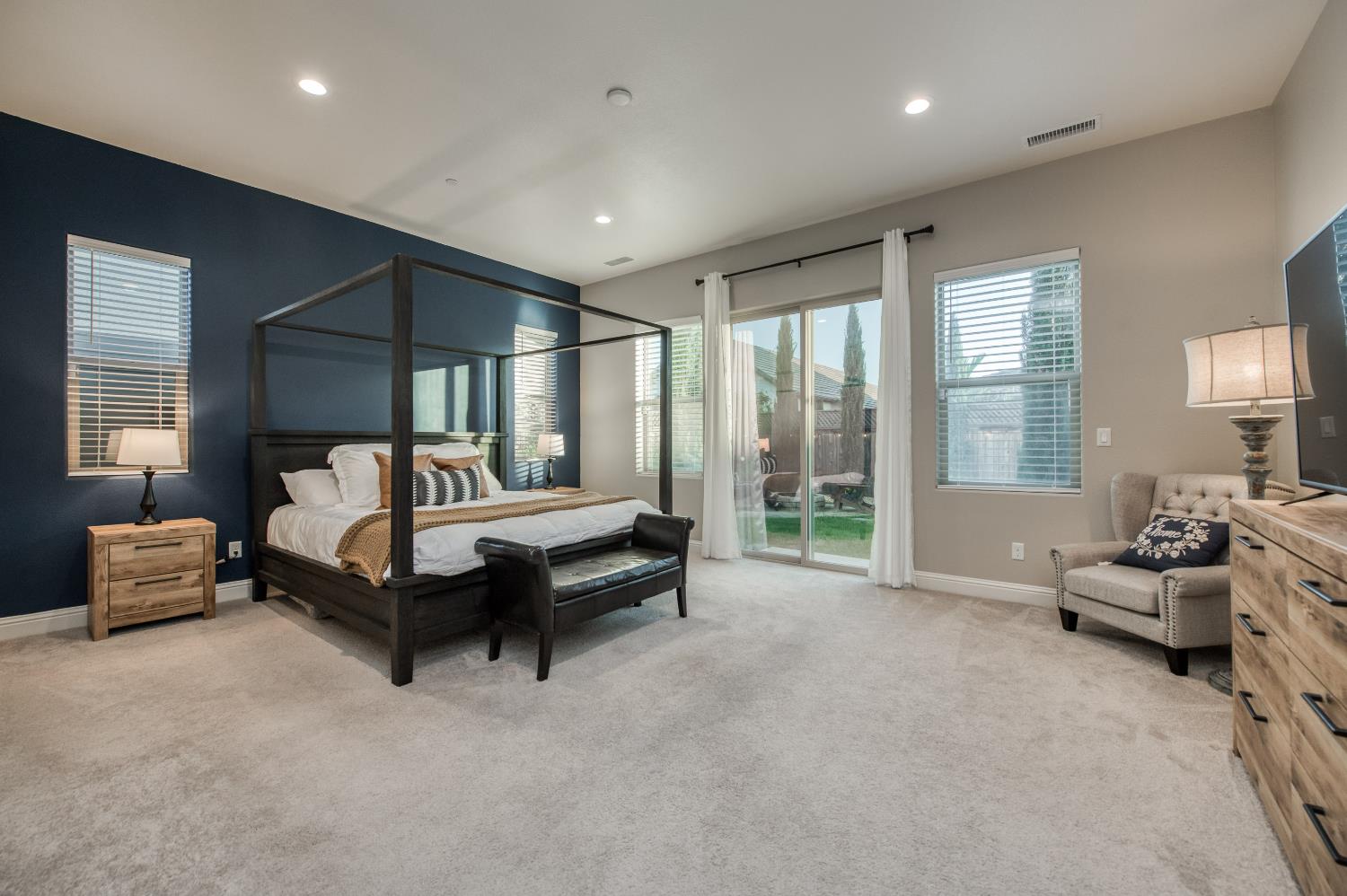 598 Crescent Lane Madera, CA 93636 - Photo 37 of 80 a spacious bedroom with a bed and a couch