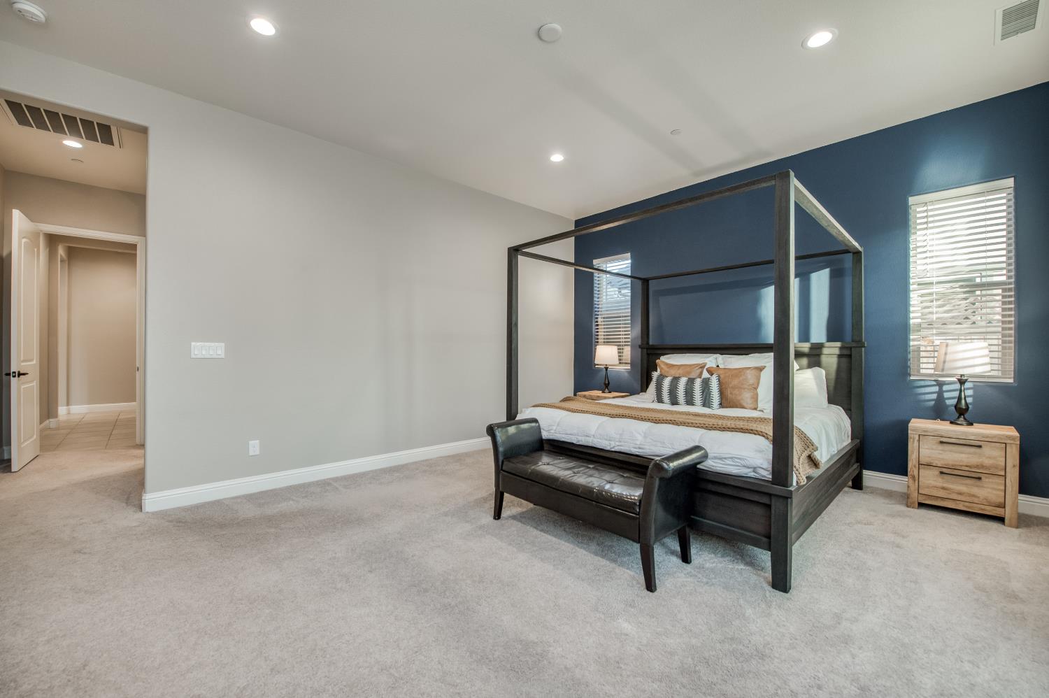 598 Crescent Lane Madera, CA 93636 - Photo 38 of 80 a spacious bedroom with a bed and a night stand