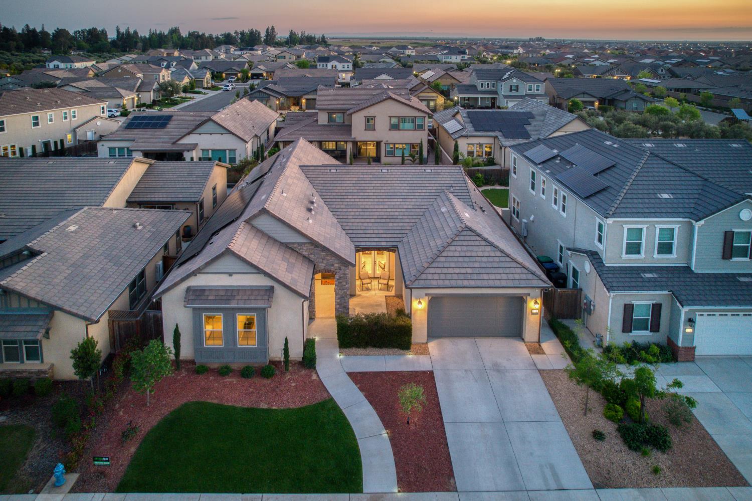 598 Crescent Lane Madera, CA 93636 - Photo 49 of 80 a front view of a house with a yard and garage