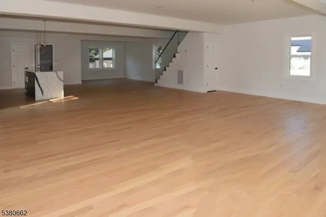 a view of empty room with window and fireplace