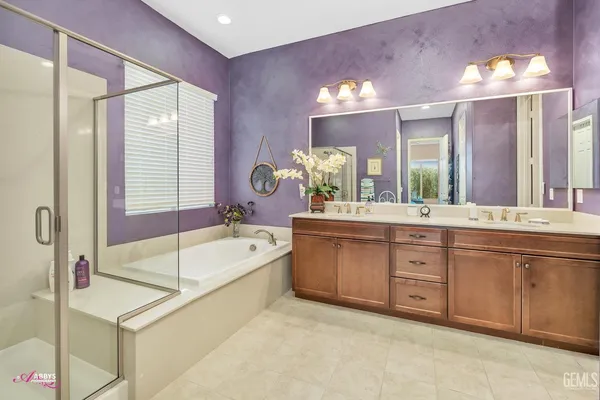 a spacious bathroom with a bathtub sink and mirror