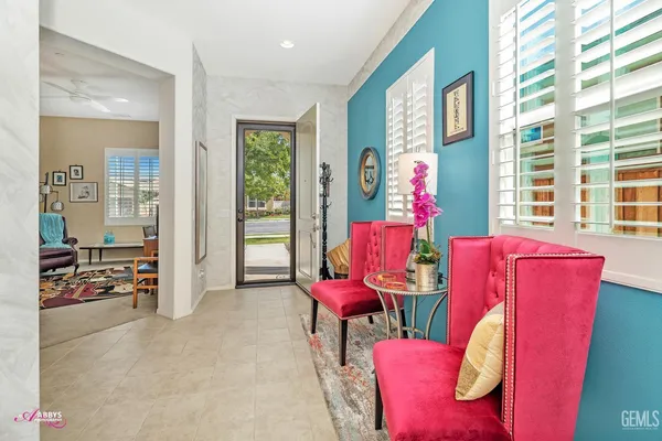 a living room with furniture flowerpot and window