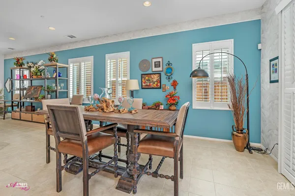 a kitchen with granite countertop kitchen island stainless steel appliances a refrigerator a sink and a counter space