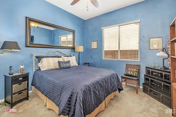 a bedroom with a bed and a tv on the dresser