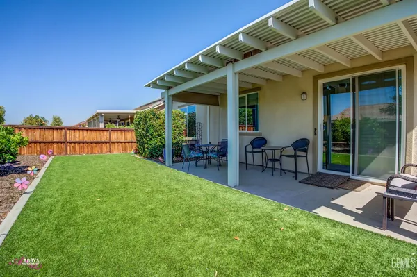 a view of a backyard with potted plants and wooden fence