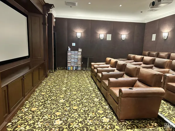 a living room with fireplace furniture and a rug