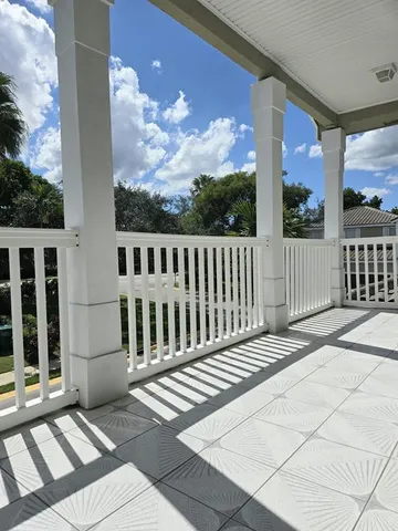 a view of a balcony with wooden floor