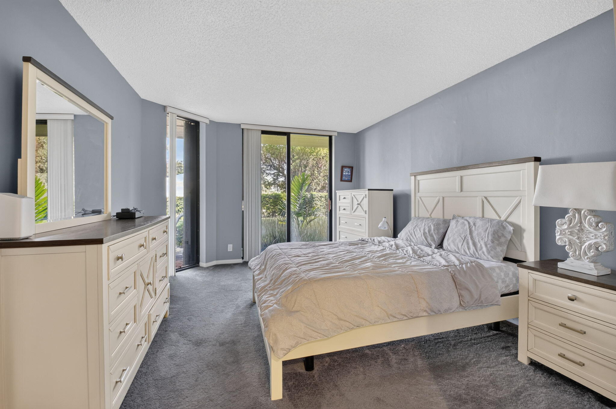1401 South Ocean Boulevard, Unit 1060 Boca Raton, FL 33432 - Photo 23 of 46 a spacious bedroom with a large bed and a wooden floor