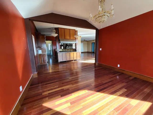 a room with wooden floor and staircase