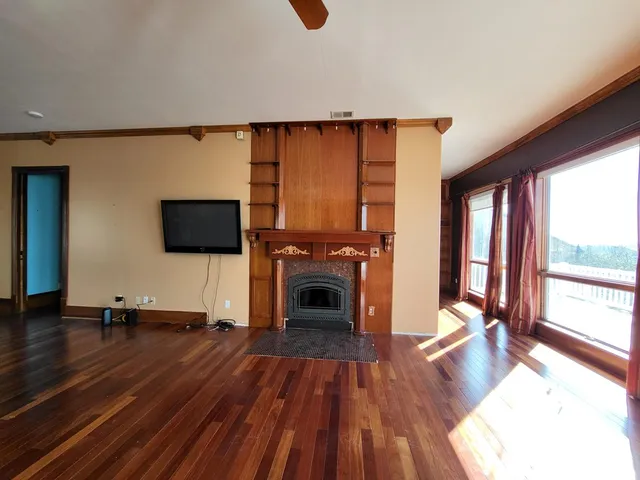 a living room with furniture fireplace and flat screen tv