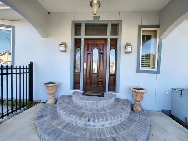 a view of a hallway with wooden floor and a dining room