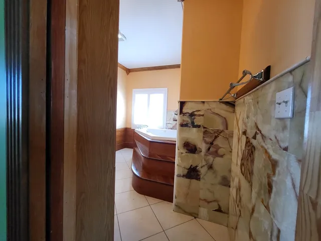 a bathroom with a bathtub and shower