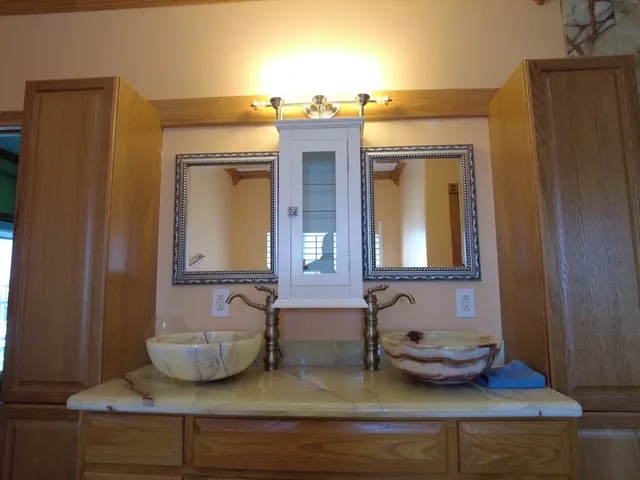 a view of bathroom with double vanity and mirror