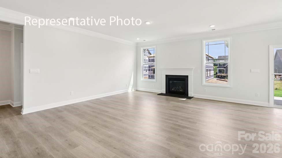 7601 Bainbridge Road Sherrills Ford, NC 28673 - Photo 14 of 34 a view of a livingroom with wooden floor and a ceiling fan