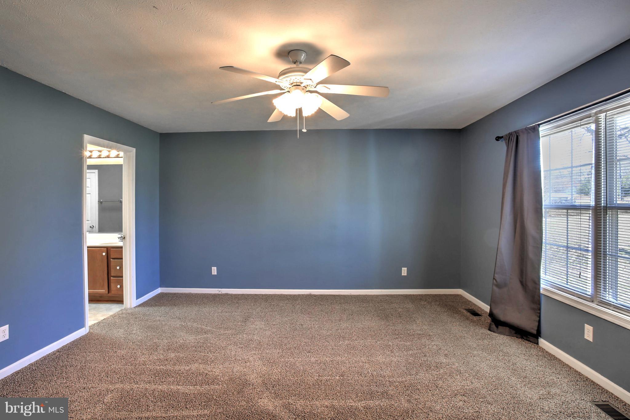 180 Spring Road Mineral, VA 23117 - Photo 11 of 22 an empty room with windows and fan