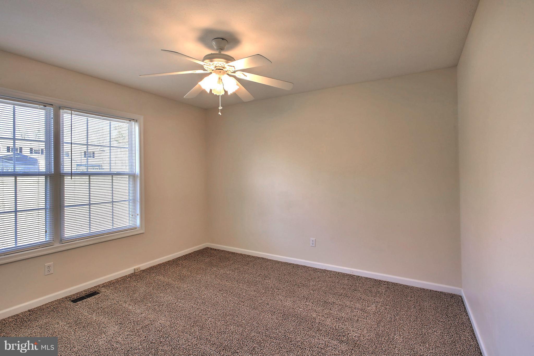180 Spring Road Mineral, VA 23117 - Photo 15 of 22 an empty room with windows and fan