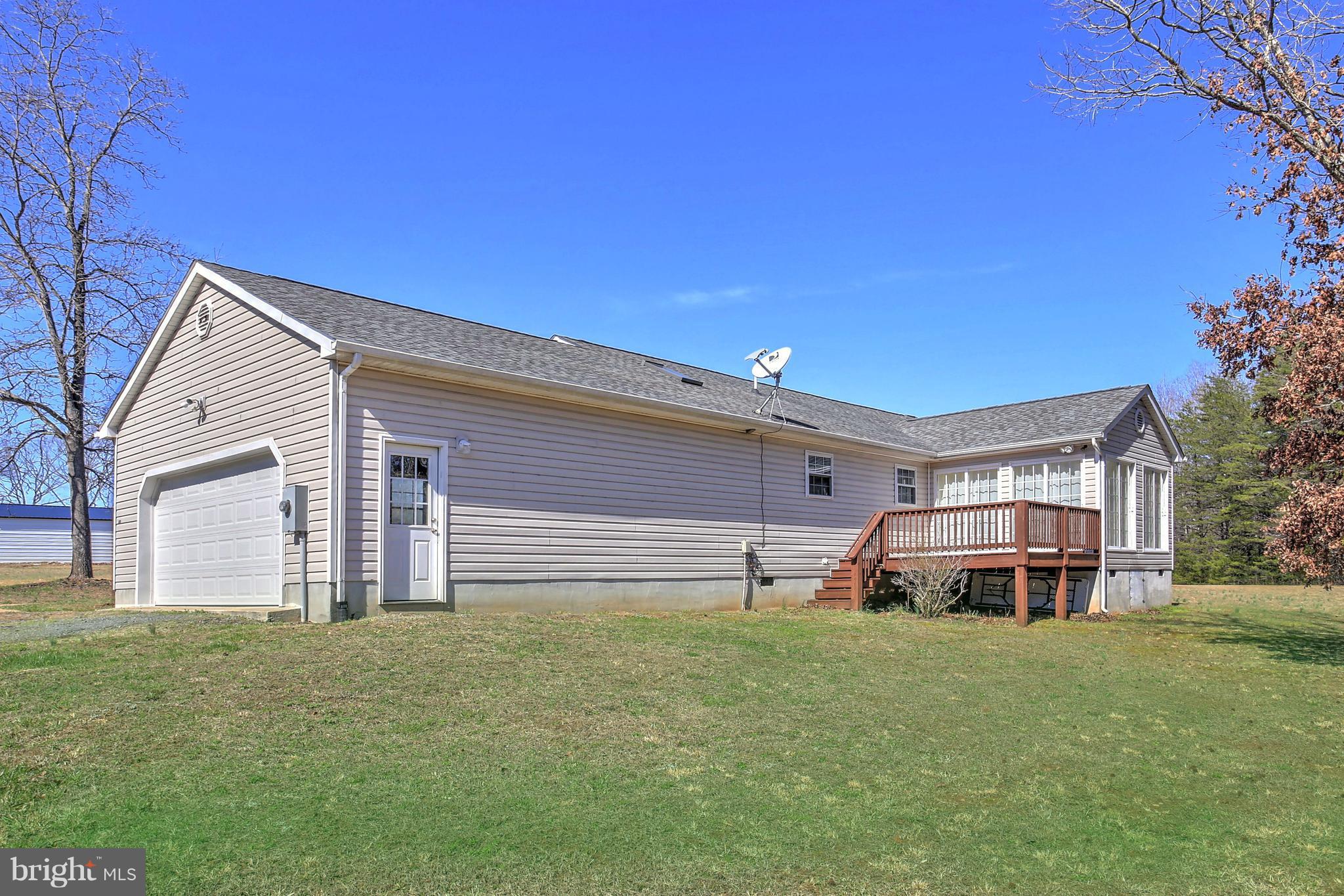 180 Spring Road Mineral, VA 23117 - Photo 18 of 22 a front view of a house with a garden and deck