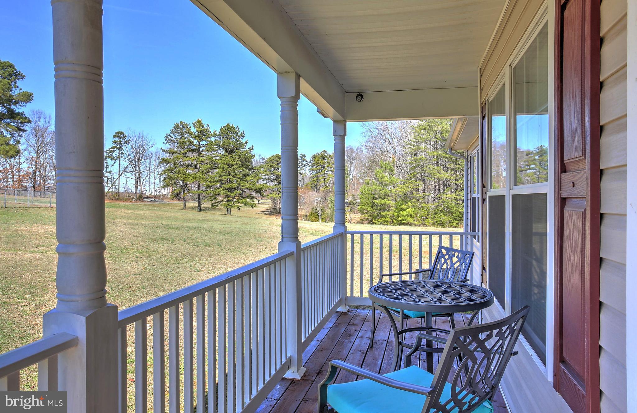 180 Spring Road Mineral, VA 23117 - Photo 3 of 22 a view of a balcony with table and chairs and wooden floor