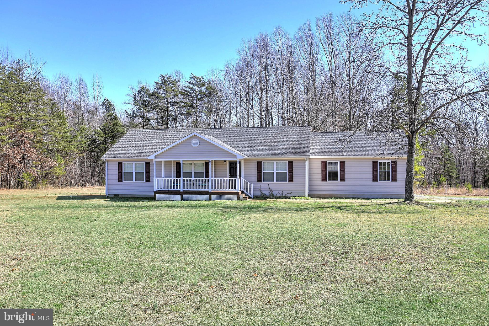 180 Spring Road Mineral, VA 23117 - Photo 22 of 22 a house that has a big yard with large trees