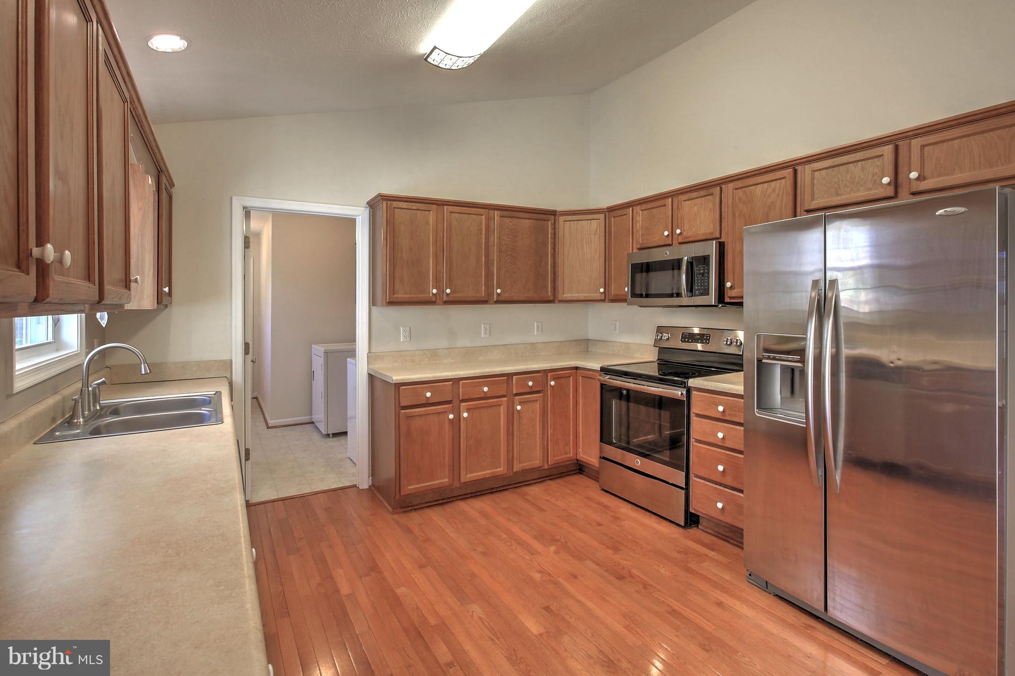 180 Spring Road Mineral, VA 23117 - Photo 6 of 22 a kitchen with granite countertop a refrigerator and a sink