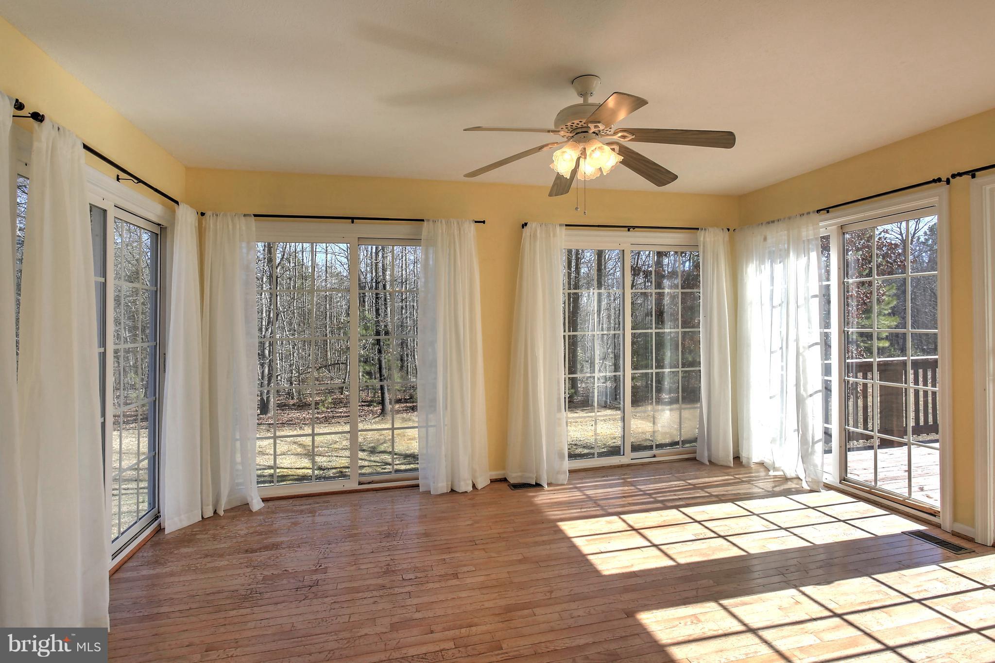 180 Spring Road Mineral, VA 23117 - Photo 9 of 22 a view of an empty room with wooden floor and a window