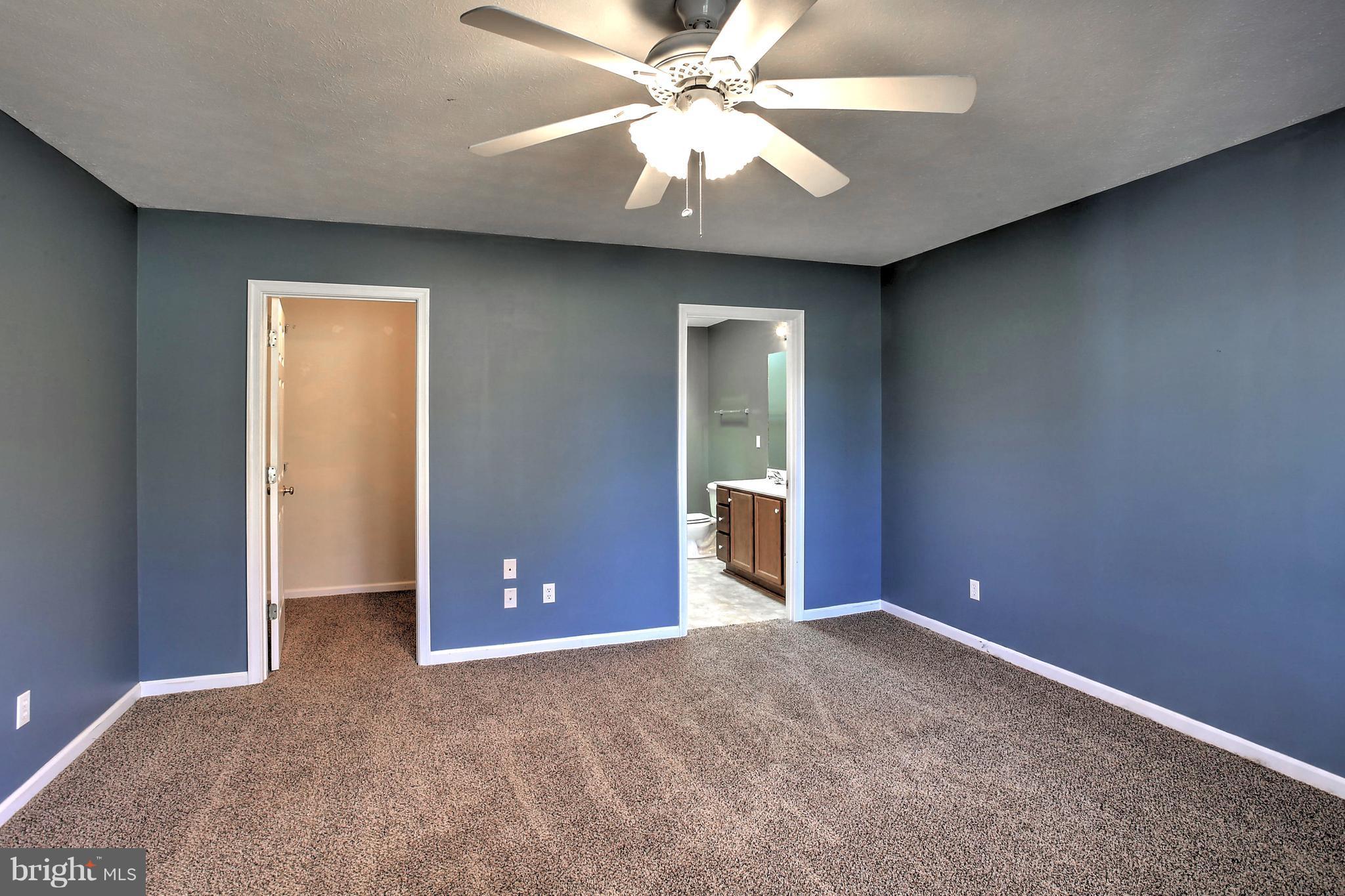 180 Spring Road Mineral, VA 23117 - Photo 10 of 22 an empty room with closet and a chandelier fan
