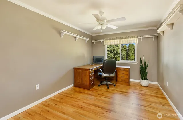 a workspace with wooden floor and a window