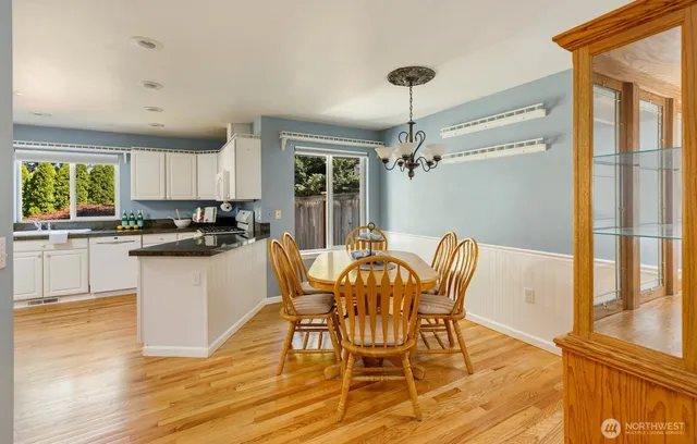 a kitchen with granite countertop wooden floors and white appliances
