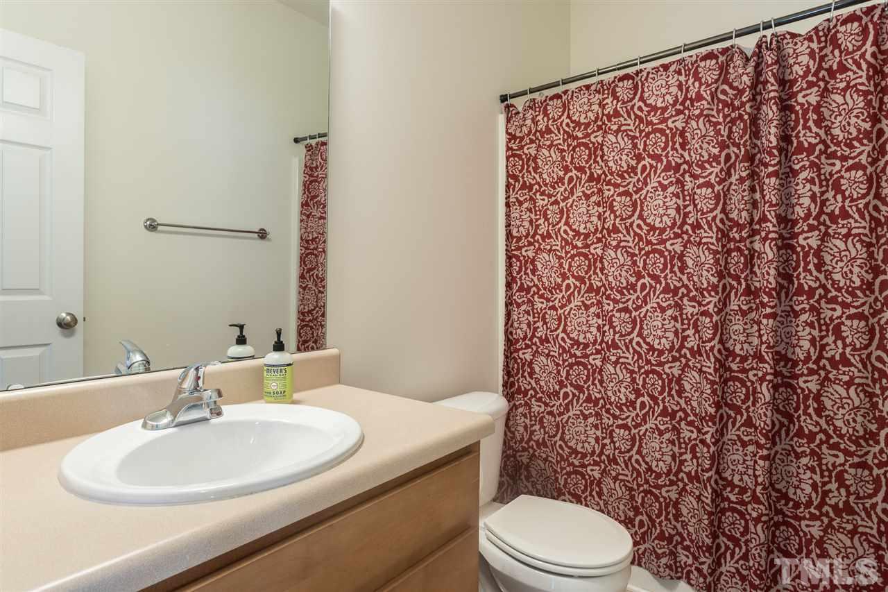 233 Cooke Street Raleigh, NC 27601 - Photo 22 of 27 The second and third bedroom share a full bathroom in the hallway.